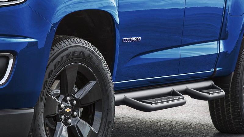 A blue Chevrolet Colorado, highlighting the door, foot rest, ground clearance, and wheel.