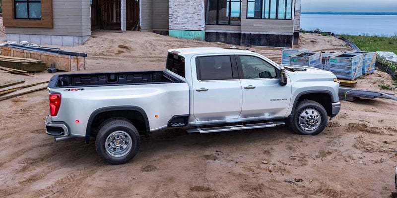 Chevrolet Silverado 2500 HD parked in front of a house with construction in the background.