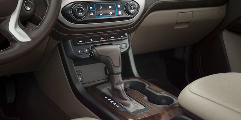 The gear shift and controller of a GMC Canyon, featuring the center console and nearby controls.