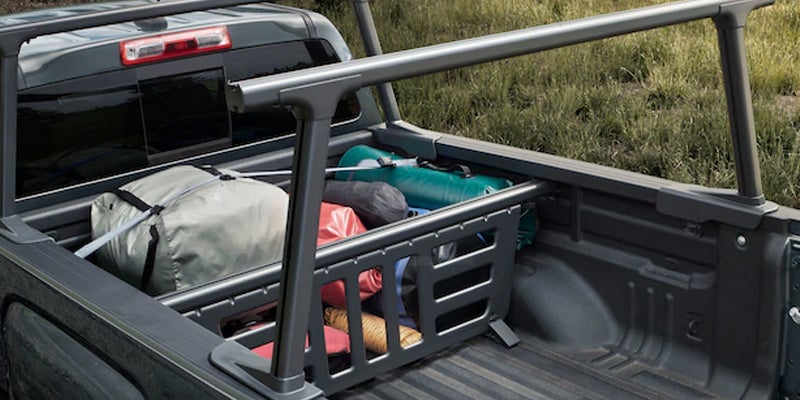The trunk of a GMC Canyon truck, with a few bags placed inside the truck.
