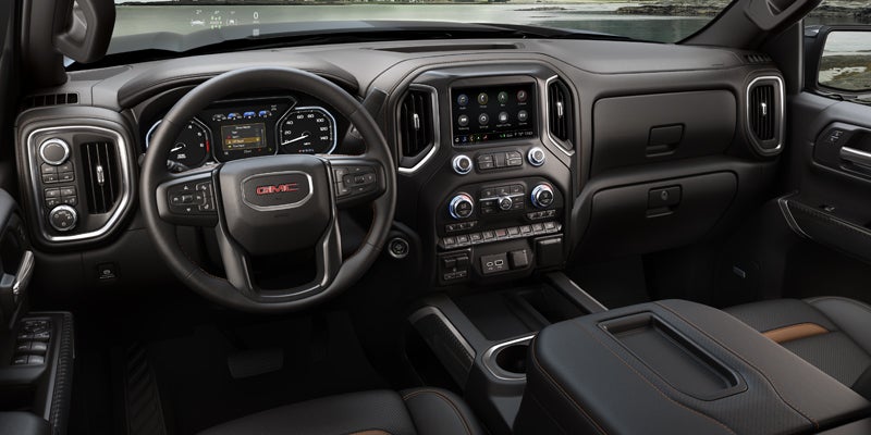 Interior of a GMC Sierra 1500, focusing on the dashboard, steering wheel, and center console.
