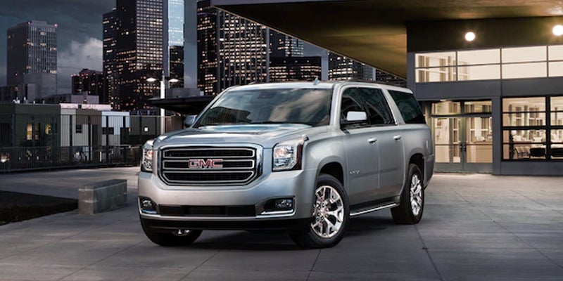 front view of a 2019 GMC Yukon with a building in the background.