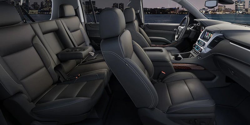The interior of a 2019 GMC Yukon, displaying the seats, dashboard, and detailed design of the cabin.