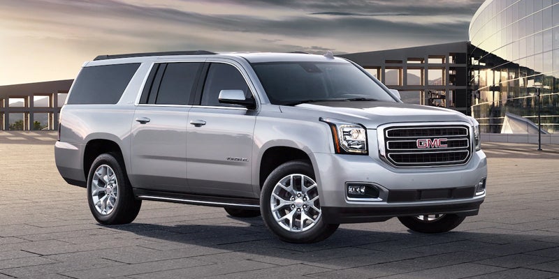 2019 GMC Yukon, shown in a side profile, highlighting its sleek design and bold features.