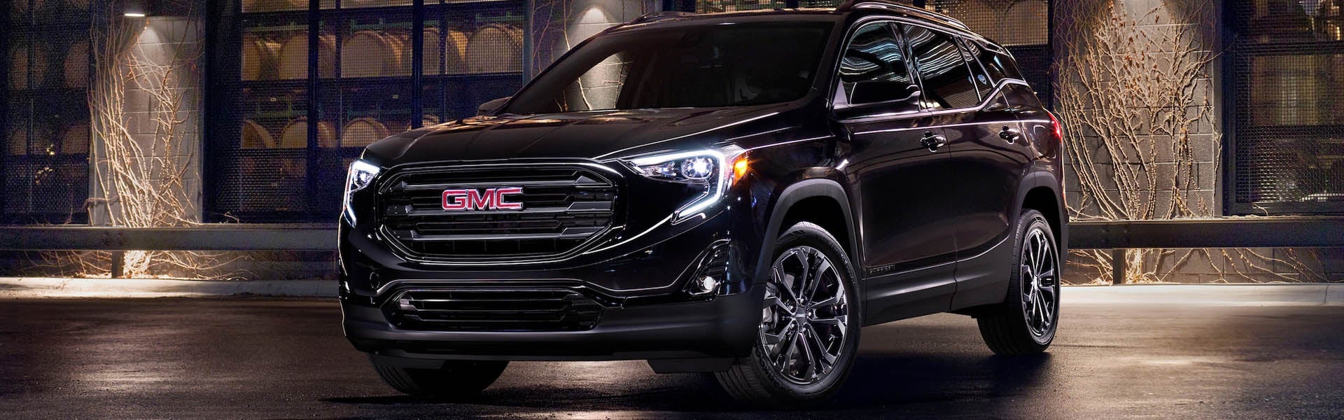 A shining brown 2020 GMC Terrain parked, showcasing its sleek design and polished exterior.