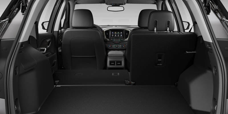 The rear seat of a GMC Terrain folded down, revealing the spacious trunk area.
