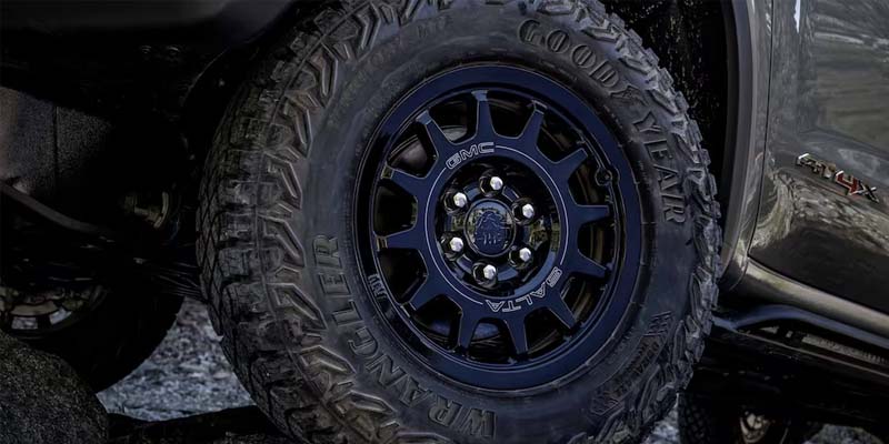 wheel of a GMC Sierra 1500, showcasing its durable design and rugged capabilities.